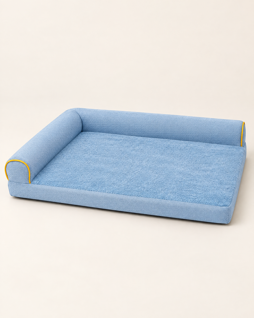 Flat dog bed with raised bolster and yellow piping, light blue